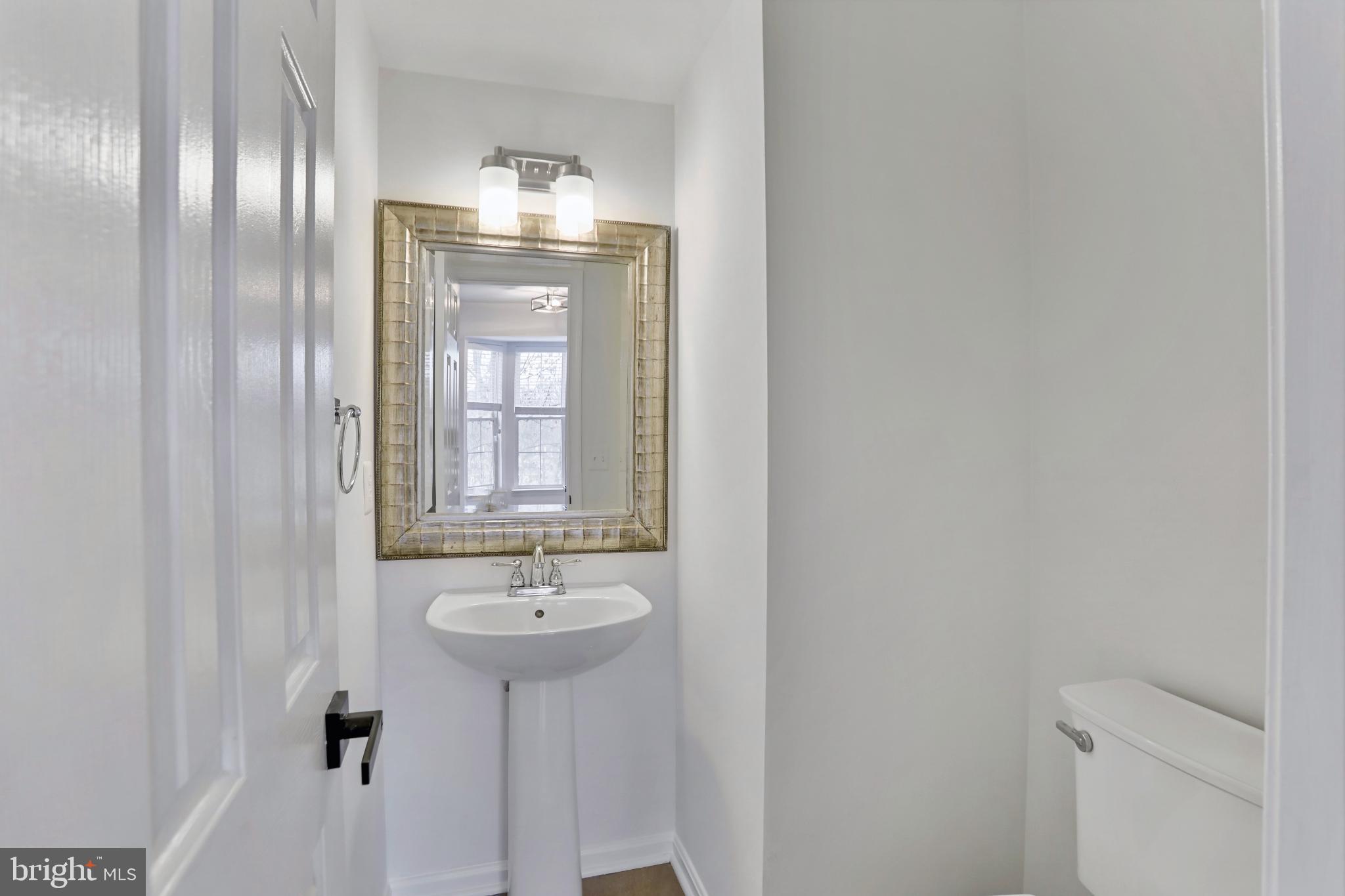 20381 Farmgate Terrace Ashburn, VA 20147 - Photo 12 of 31 a bathroom with a sink and a mirror