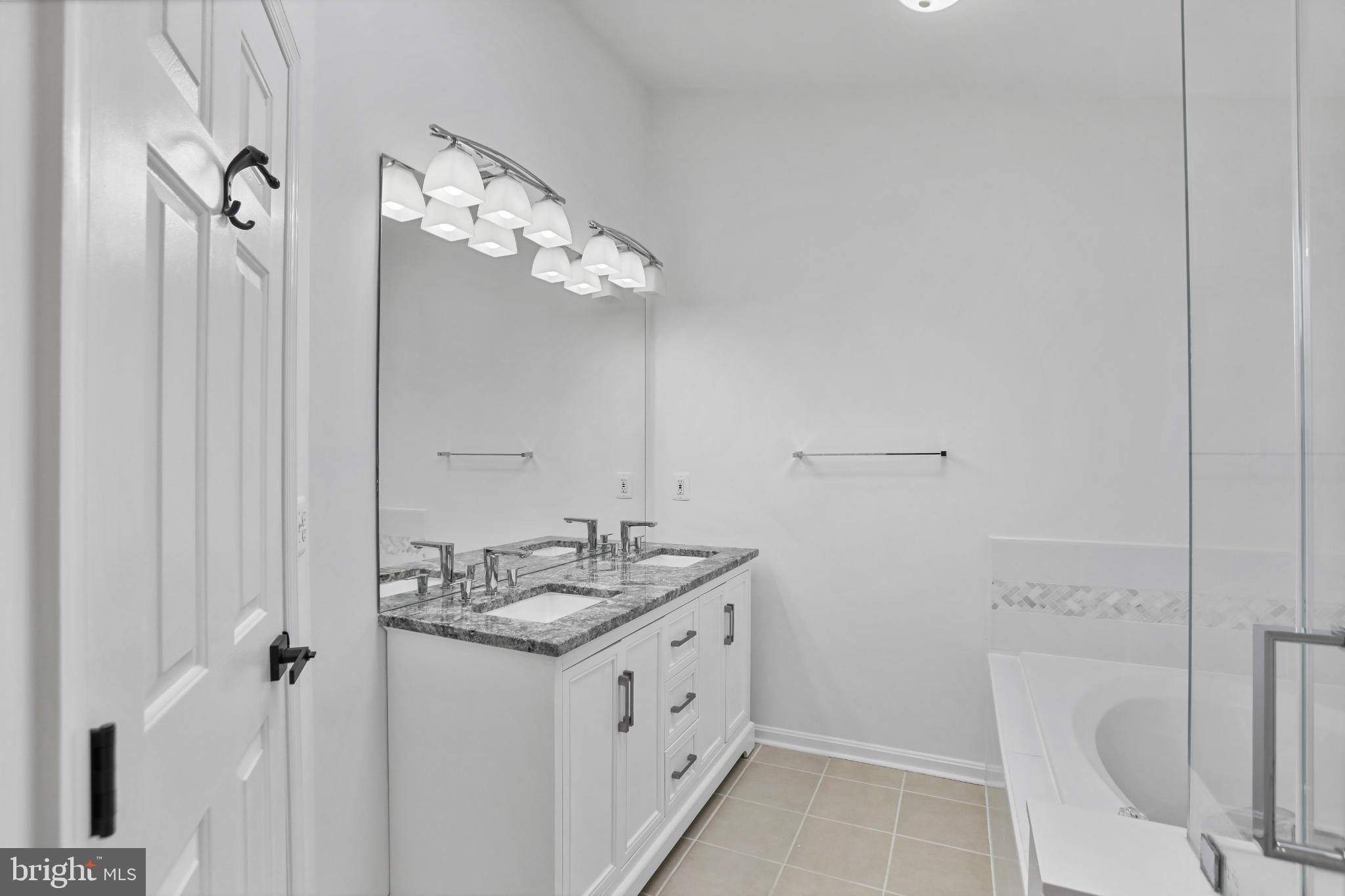 20381 Farmgate Terrace Ashburn, VA 20147 - Photo 16 of 31 a bathroom with a granite countertop sink a toilet and shower