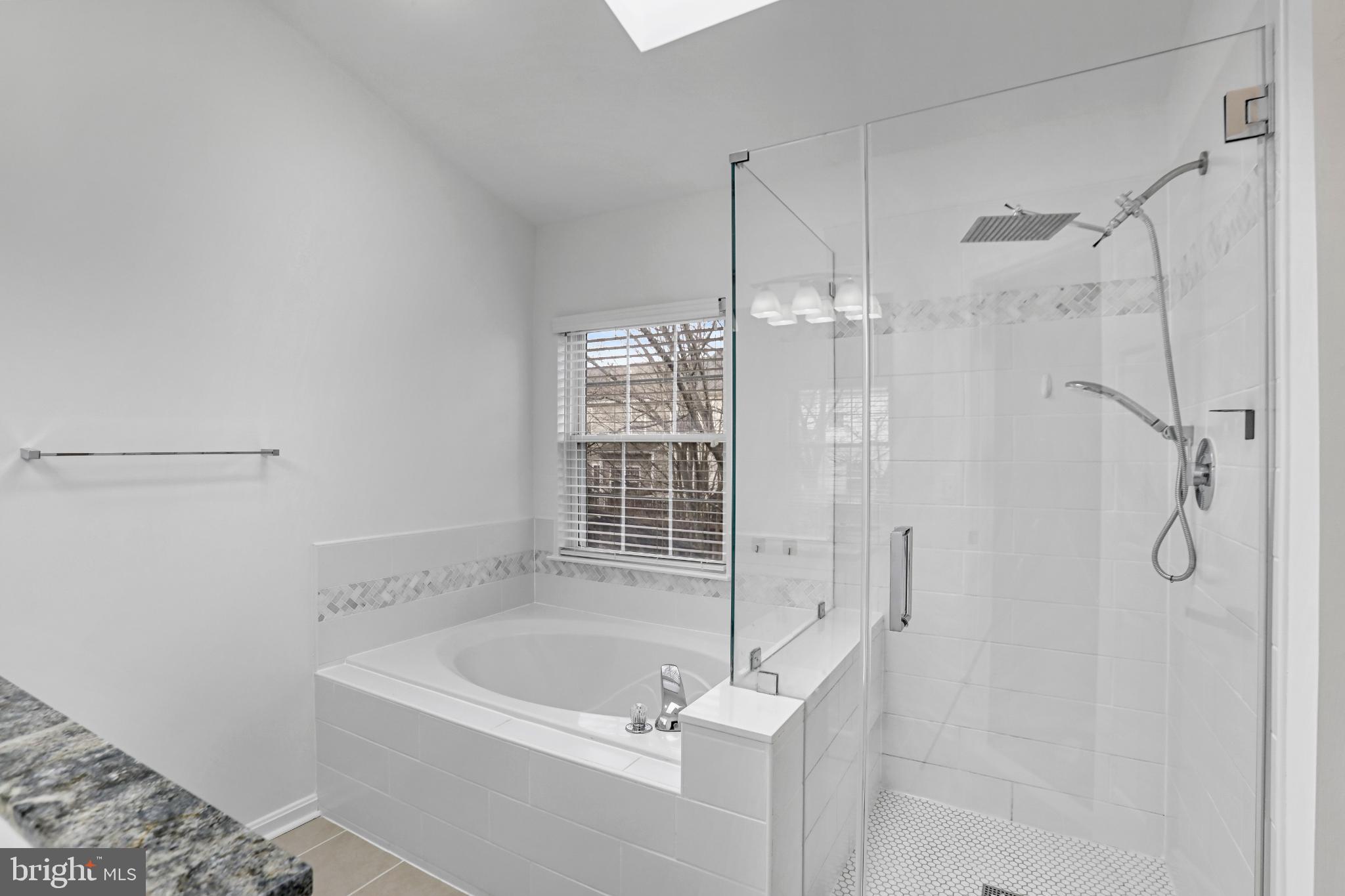 20381 Farmgate Terrace Ashburn, VA 20147 - Photo 17 of 31 a bathroom with a bath tub and shower