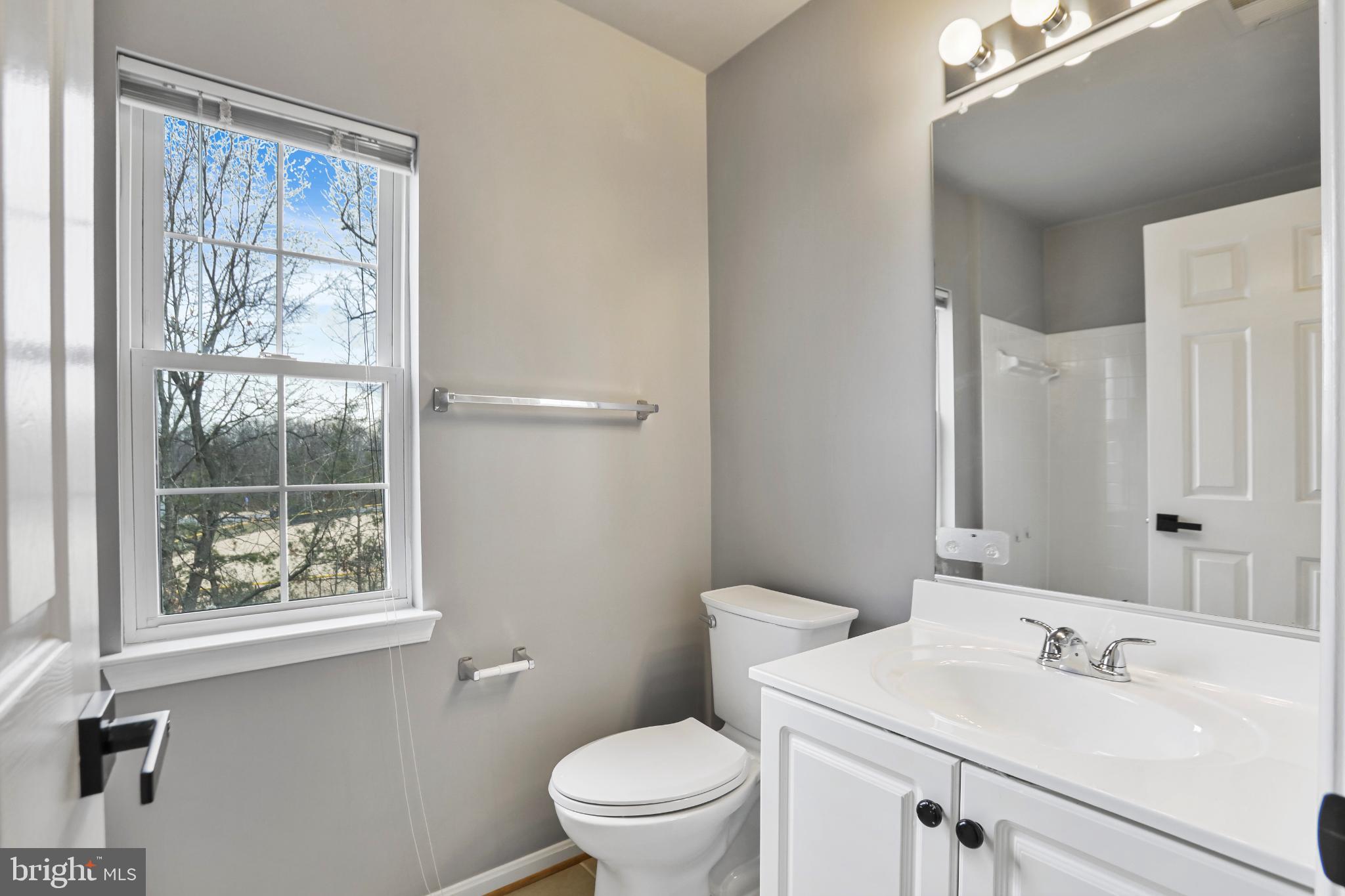 20381 Farmgate Terrace Ashburn, VA 20147 - Photo 21 of 31 a bathroom with a sink a toilet and a window