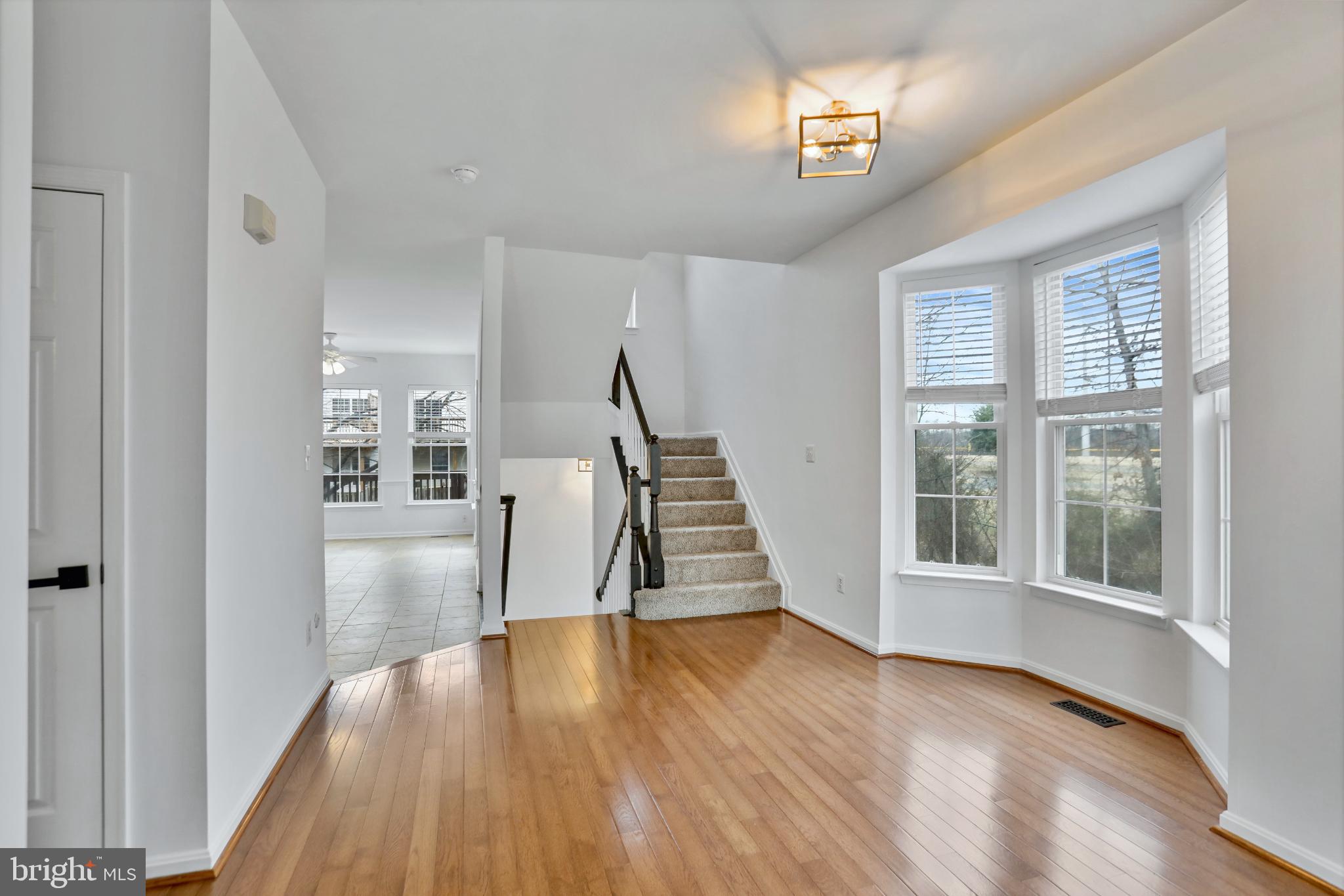 20381 Farmgate Terrace Ashburn, VA 20147 - Photo 3 of 31 a view of an entryway with wooden floor and stairs