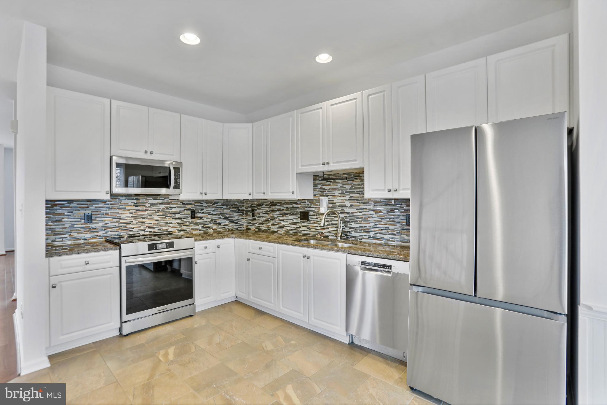 20381 Farmgate Terrace Ashburn, VA 20147 - Photo 7 of 31 a kitchen with granite countertop stainless steel appliances and white cabinets