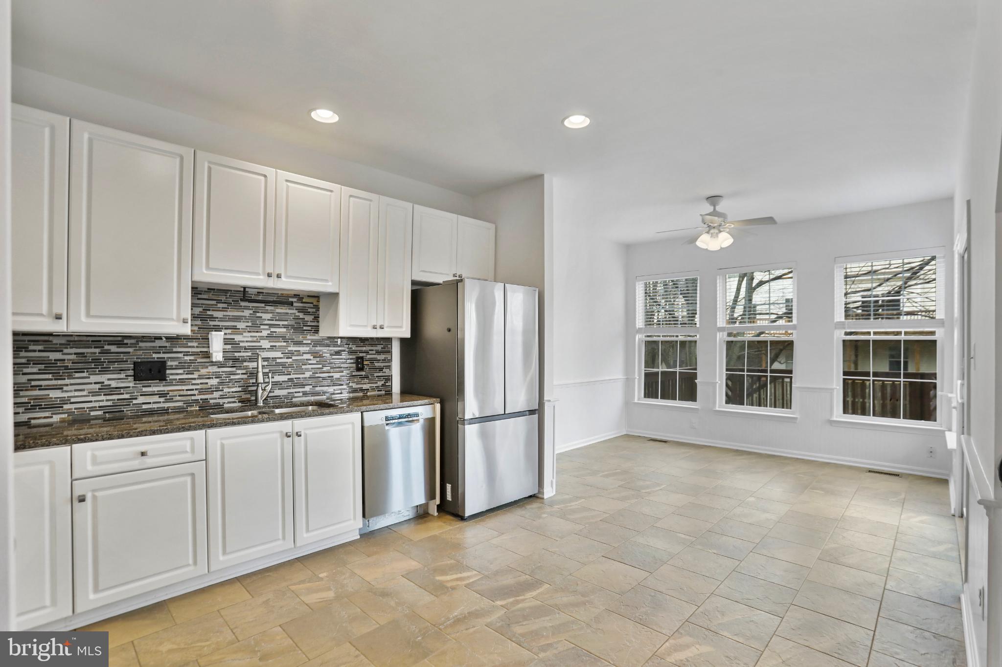 20381 Farmgate Terrace Ashburn, VA 20147 - Photo 8 of 31 a kitchen with stainless steel appliances granite countertop a refrigerator sink and cabinets