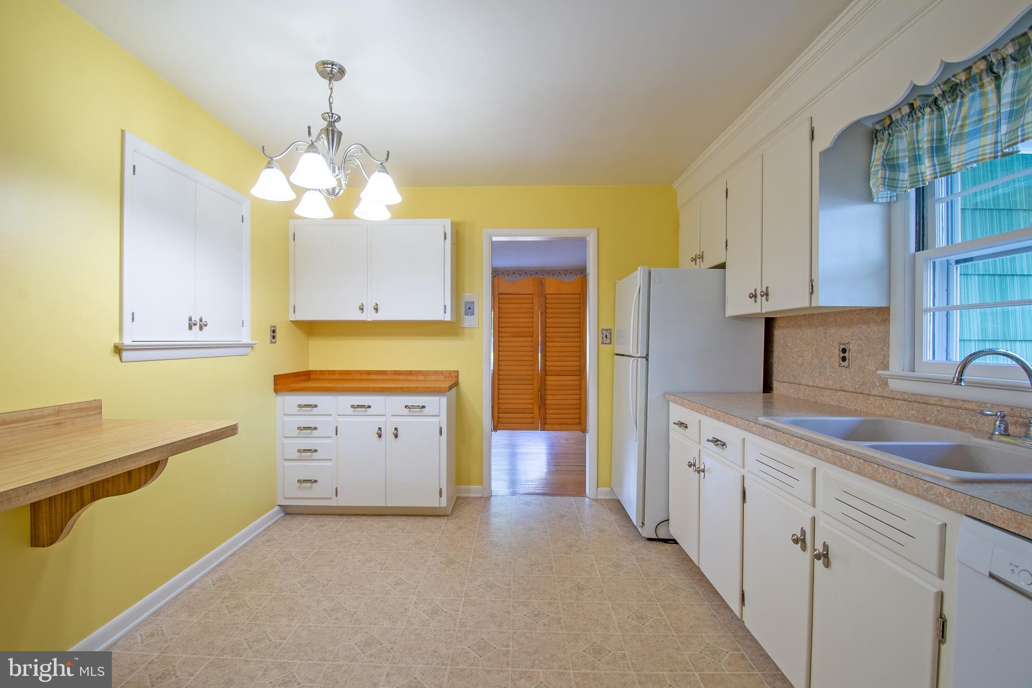 18532 Johnson Road Lincoln, DE 19960 - Photo 20 of 55 a kitchen with a refrigerator a sink dishwasher with a dining table and chairs