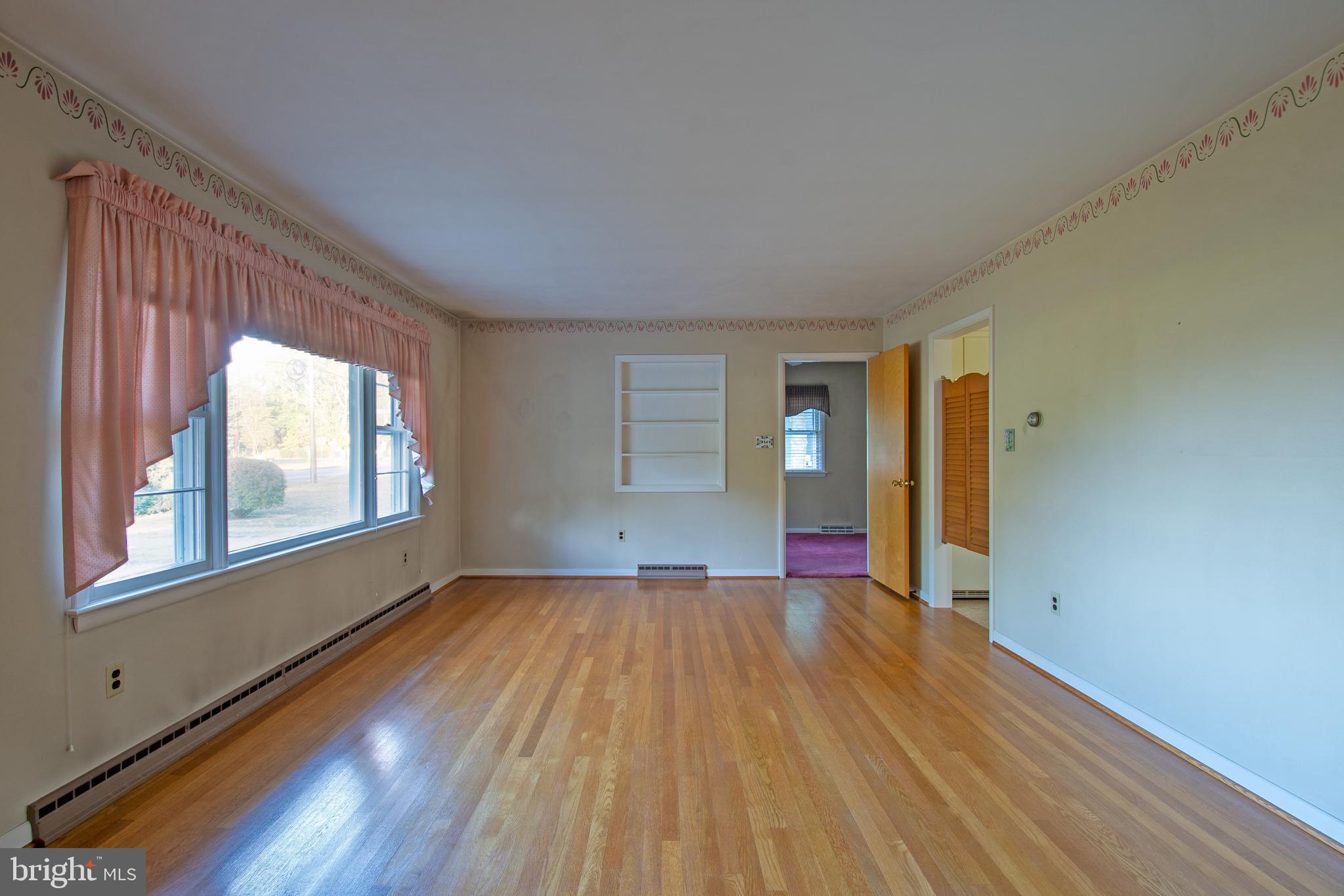 18532 Johnson Road Lincoln, DE 19960 - Photo 21 of 55 a view of an empty room with wooden floor and a window