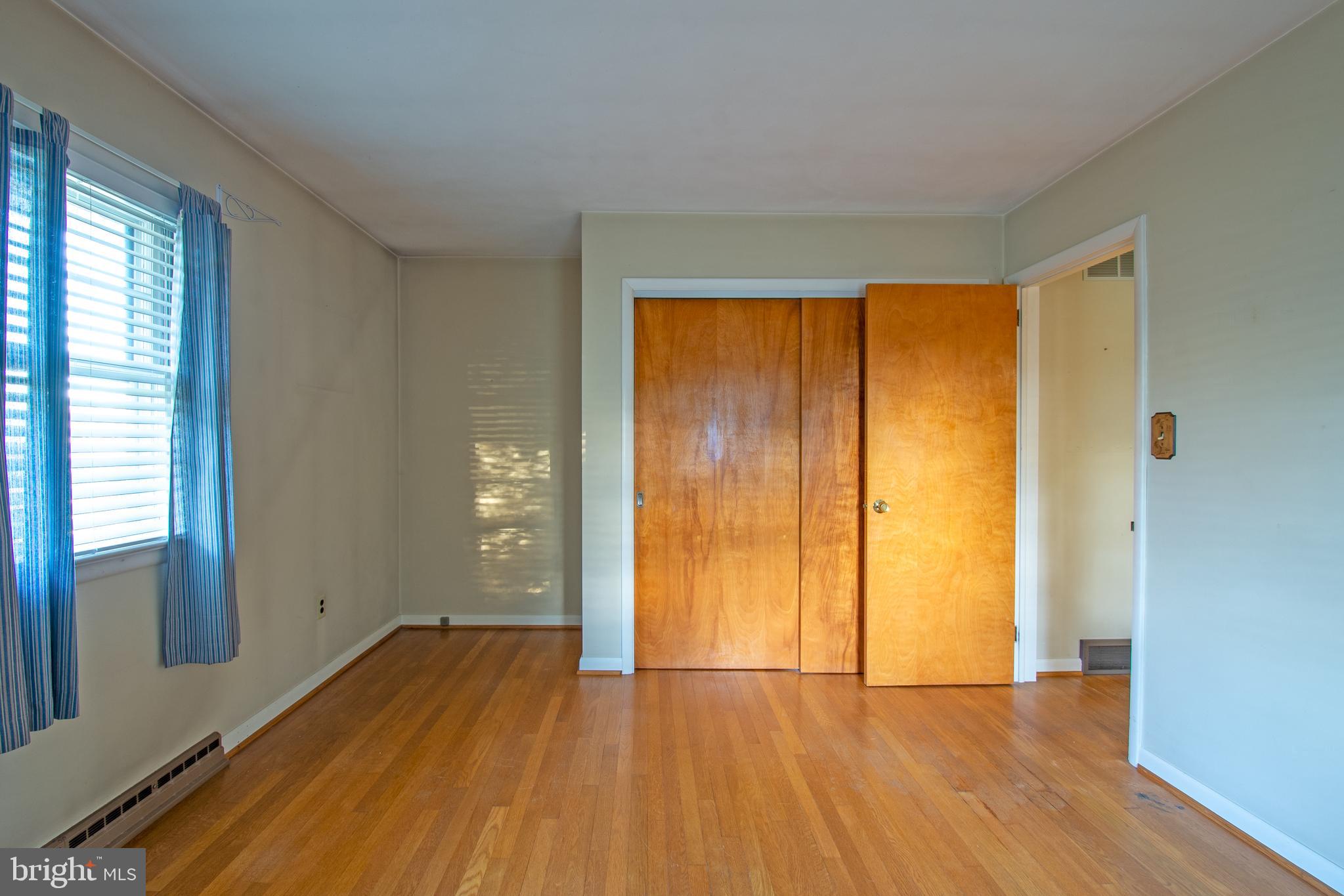 18532 Johnson Road Lincoln, DE 19960 - Photo 27 of 55 an empty room with wooden floor and windows