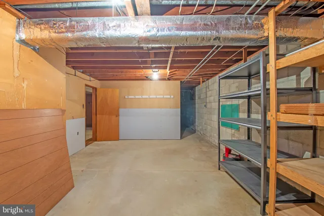 an aerial view of a residential houses with outdoor space and trees