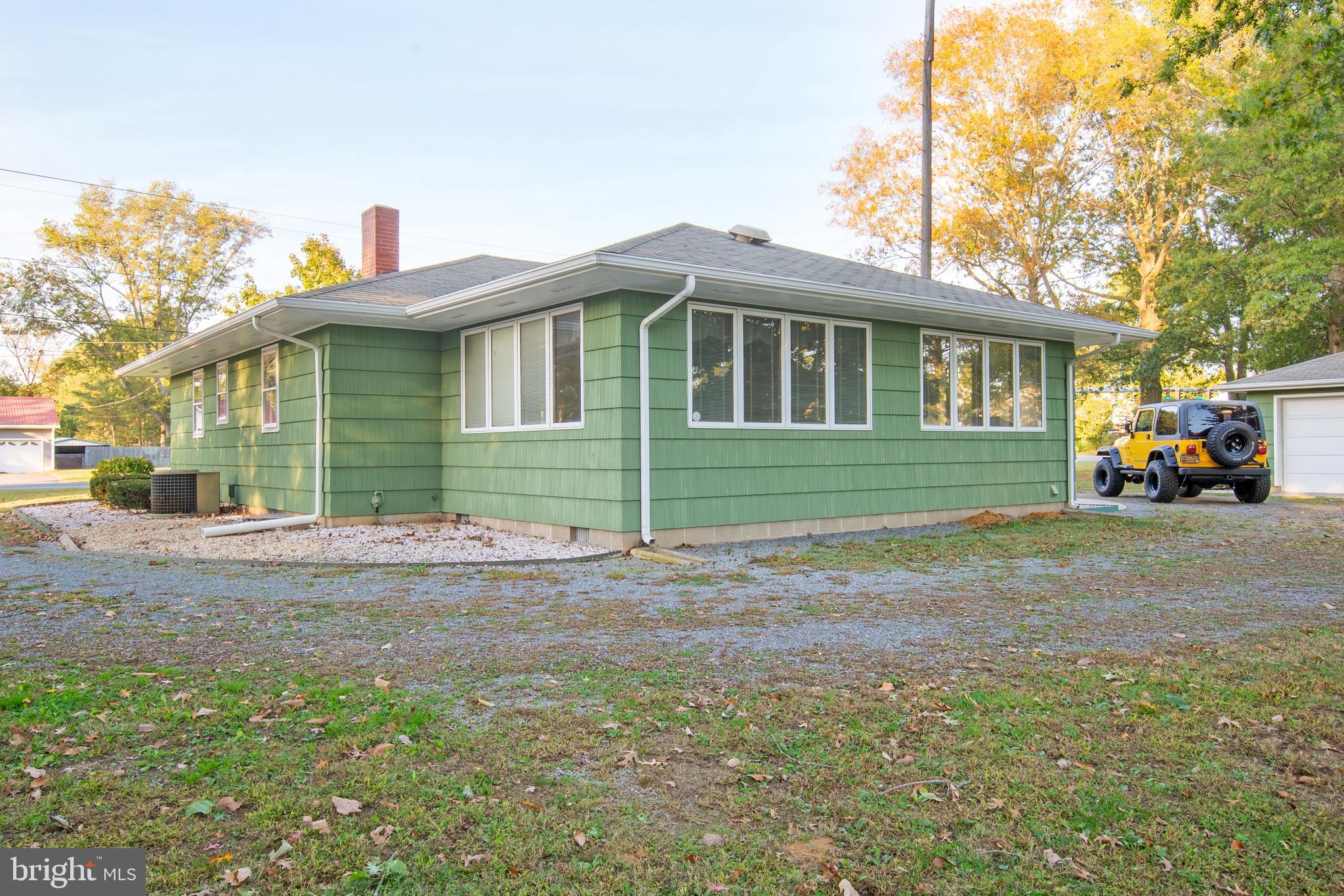 18532 Johnson Road Lincoln, DE 19960 - Photo 5 of 55 a front view of a house with a garden