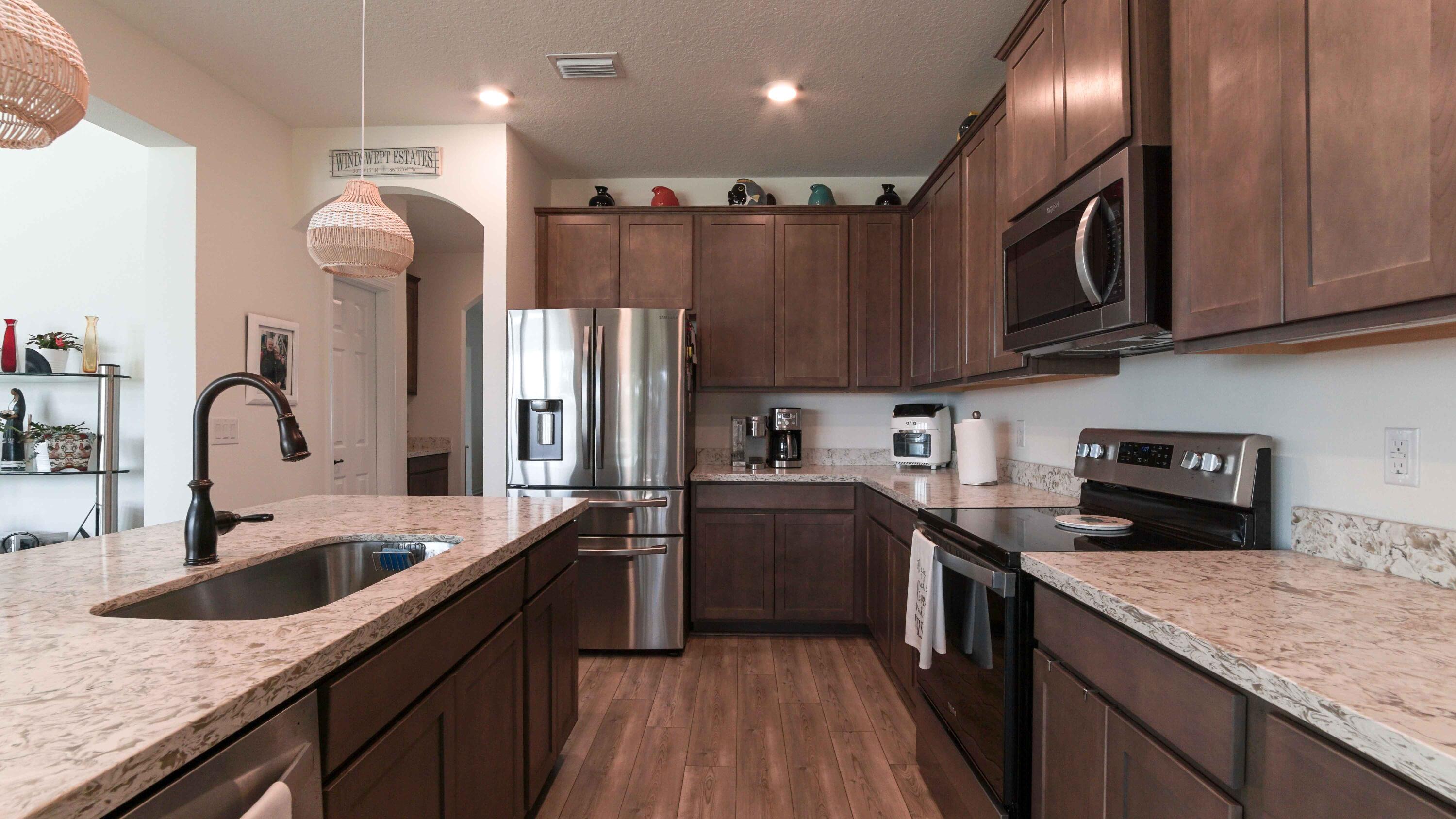 322 Fairway Crossing Freeport, FL 32439 - Photo 11 of 56 a kitchen with stainless steel appliances granite countertop a sink a stove and refrigerator