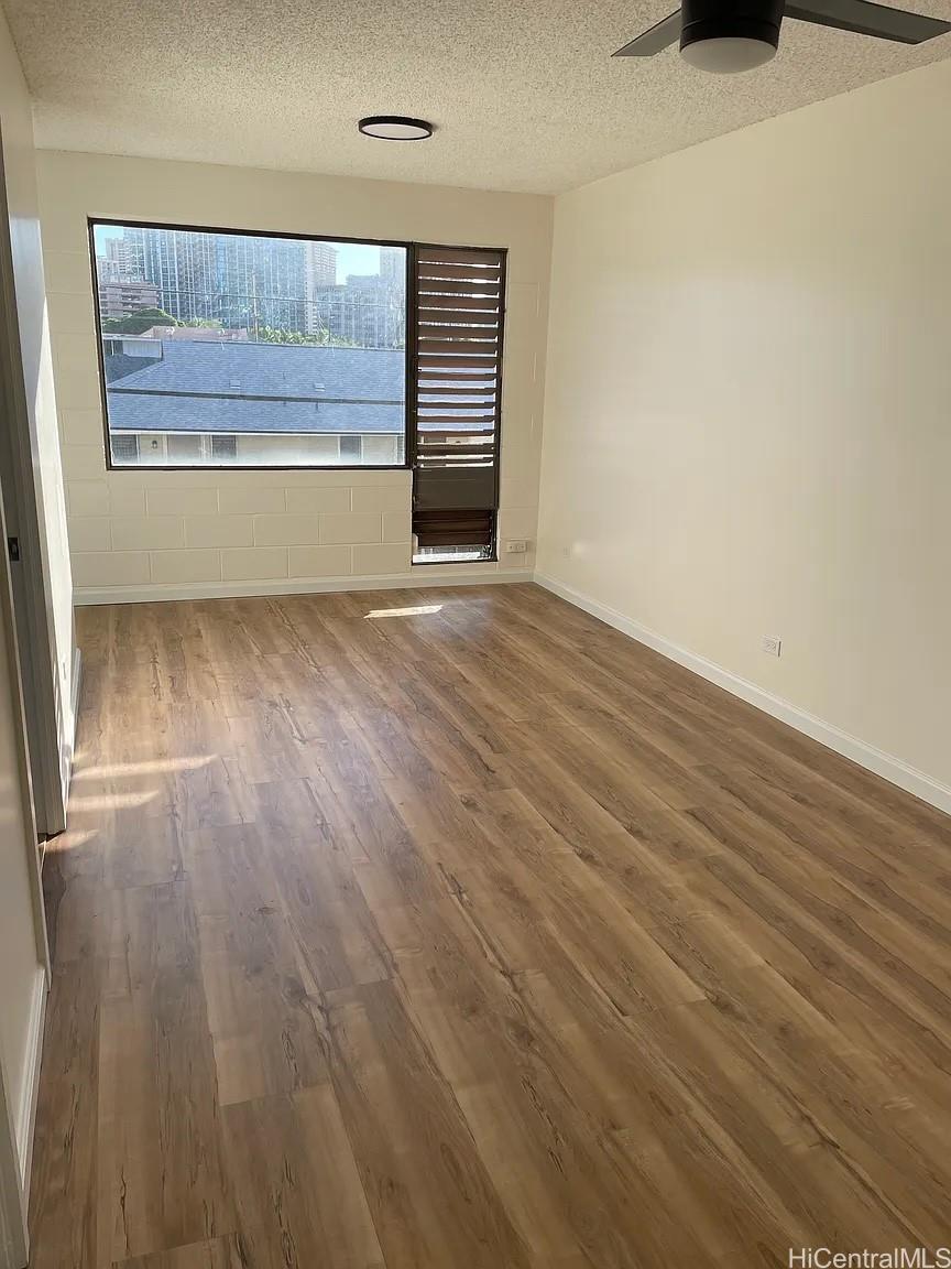 1906 Fern Street, Unit 304 Honolulu, HI 96826 - Photo 1 of 6 a view of a room with wooden floor and a window