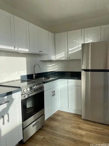 a kitchen with a stove and a refrigerator