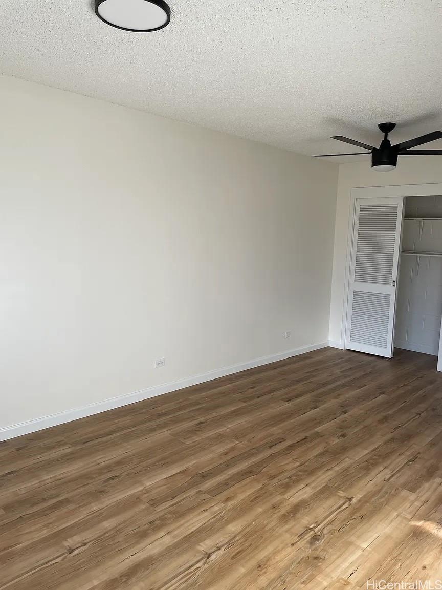 1906 Fern Street, Unit 304 Honolulu, HI 96826 - Photo 3 of 6 a view of a room with wooden floor and sink