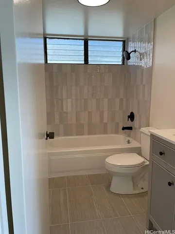 a bathroom with a toilet a sink and bathtub