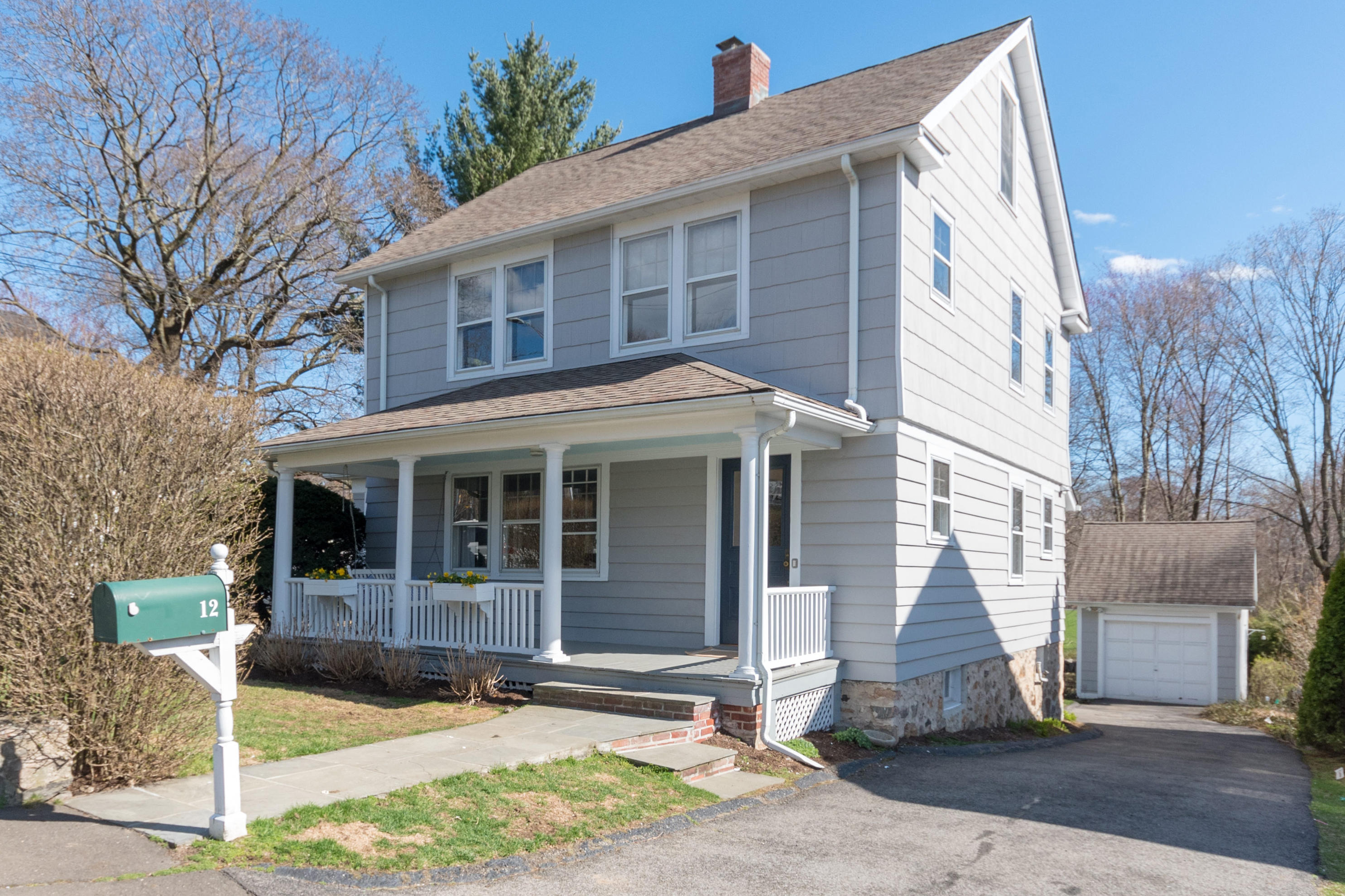 12 Maple Street Darien, CT 06820 - Photo 1 of 42 a view of a white house with large windows and plants