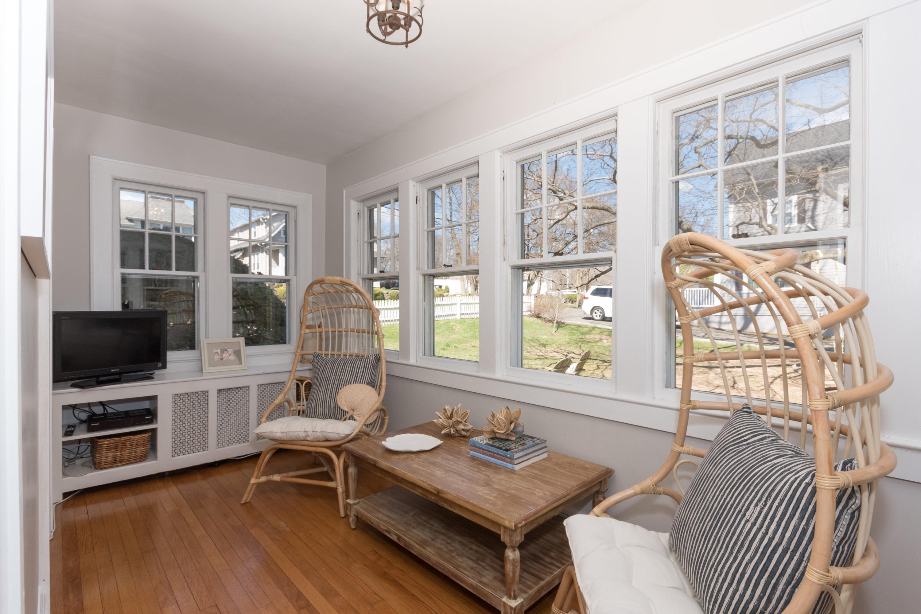 12 Maple Street Darien, CT 06820 - Photo 16 of 42 a living room with furniture a flat screen tv and large windows