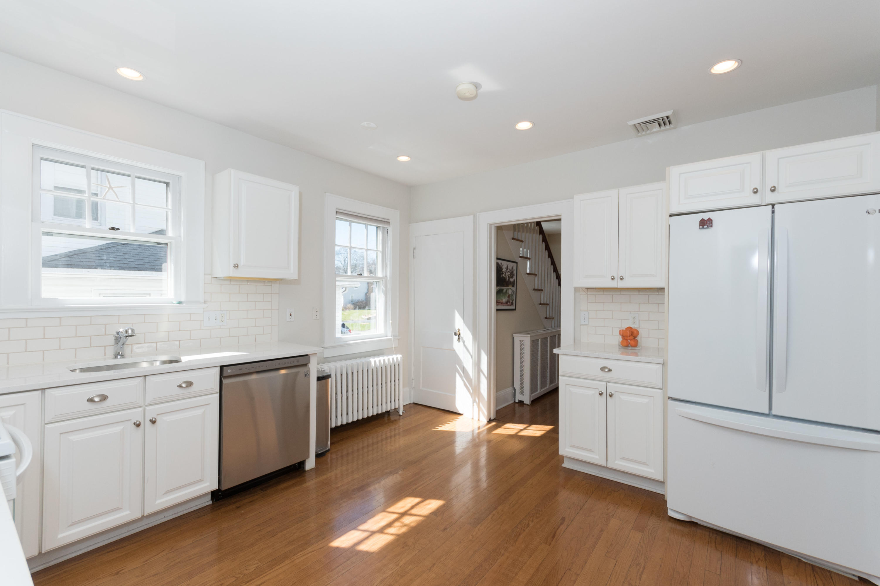12 Maple Street Darien, CT 06820 - Photo 17 of 42 a kitchen with refrigerator a sink and wooden floor