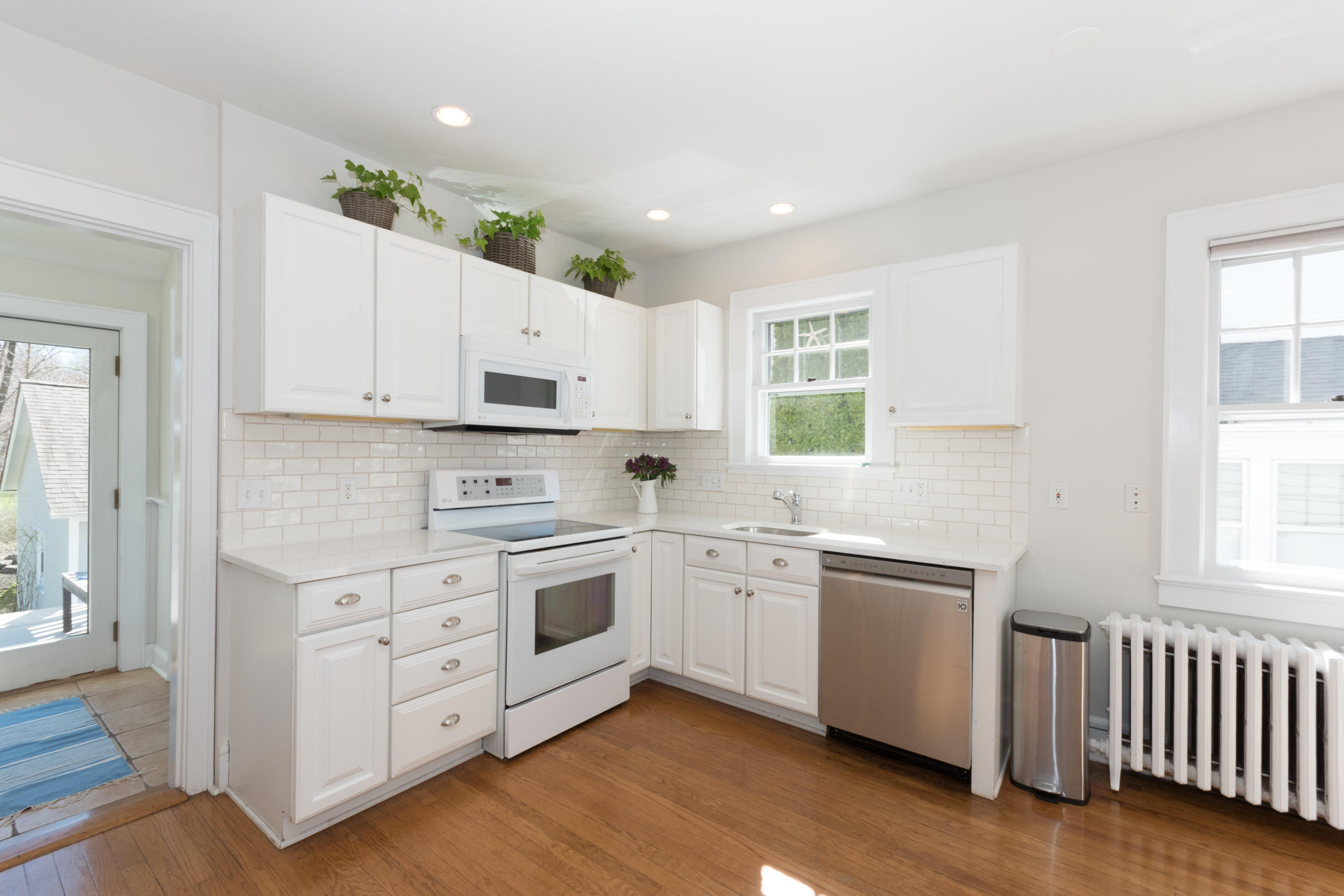 12 Maple Street Darien, CT 06820 - Photo 19 of 42 a kitchen with stainless steel appliances granite countertop a stove a sink and a microwave