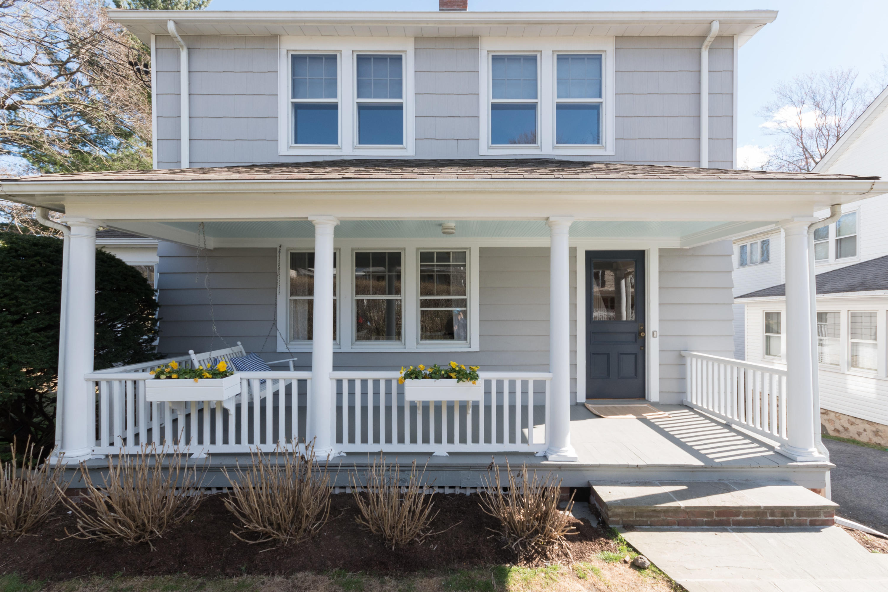12 Maple Street Darien, CT 06820 - Photo 2 of 42 front view of a brick house with a deck