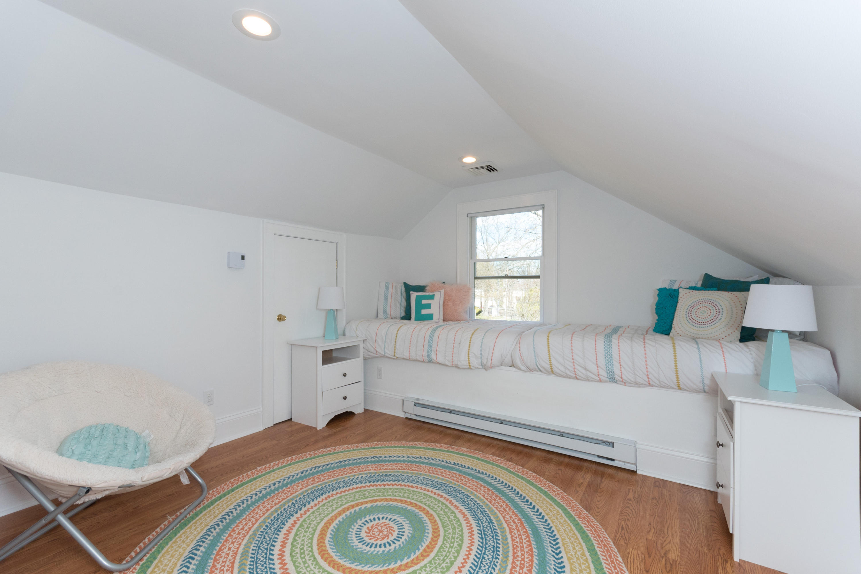 12 Maple Street Darien, CT 06820 - Photo 30 of 42 a bedroom with a white bed and a couch
