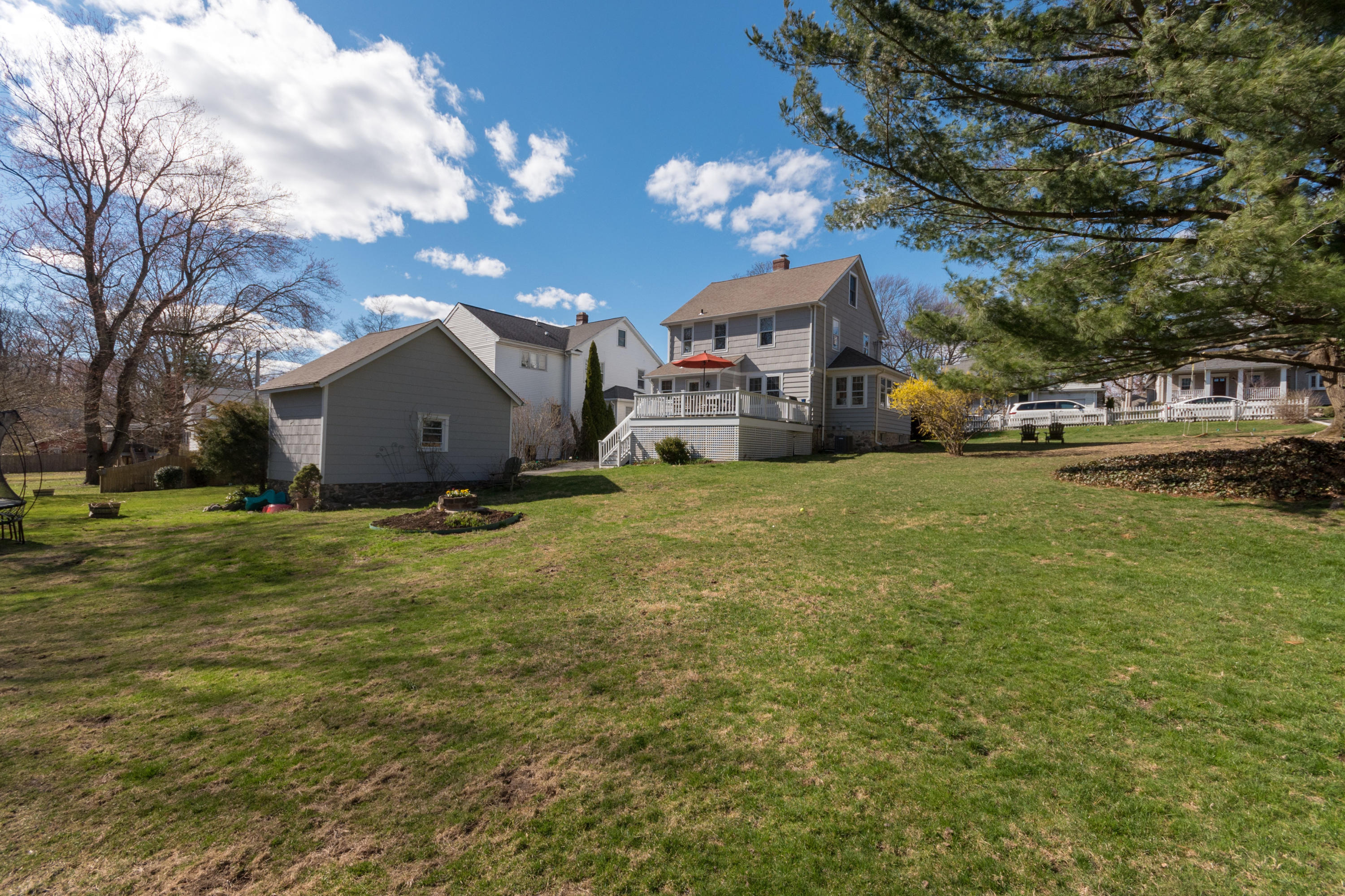12 Maple Street Darien, CT 06820 - Photo 35 of 42 a view of a house with a big yard and large trees