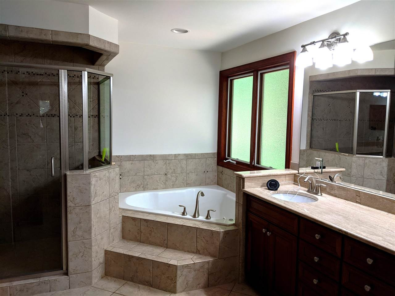 8529 Sawyer Drive Raleigh, NC 27613 - Photo 16 of 28 Luxury owner's suite bathroom features cherry cabinets, tile flooring, step-up whirlpool tub, private water closet, and tiled walk-in shower. This room was previously the master bedroom before renovations. Master Bath/Spa