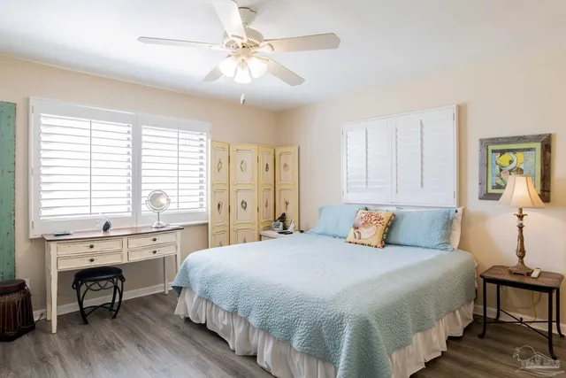 a bedroom with a large bed and a table chair