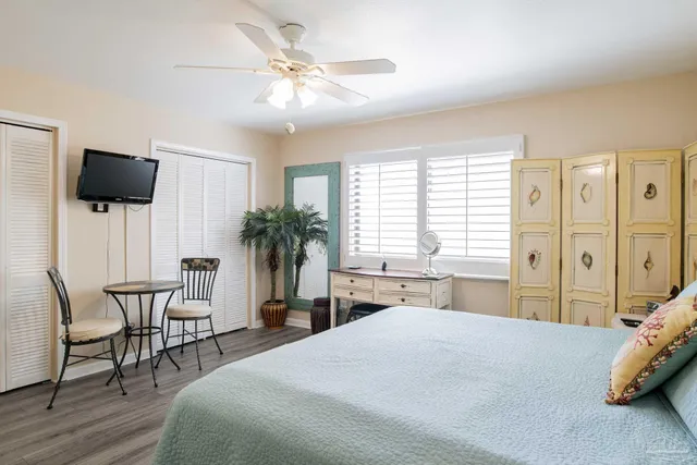 a bedroom with a bed a window and a chair