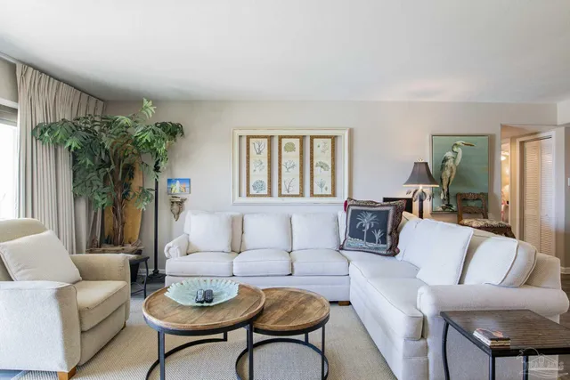 a living room with furniture and a potted plant
