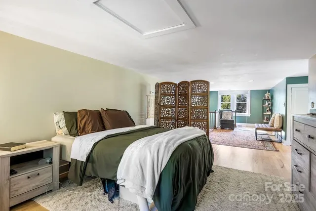 a spacious bedroom with a bed and a walk in closet