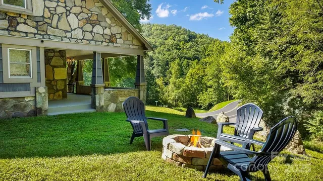 a front view of a house with garden and sitting area
