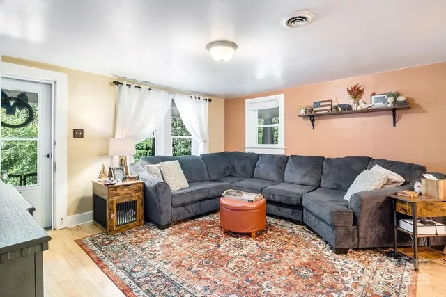 a living room with furniture and a large window