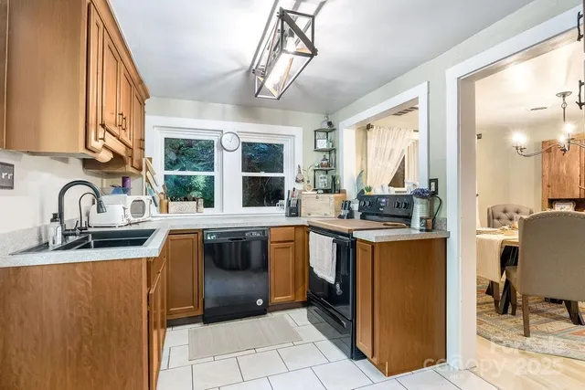 a kitchen with stainless steel appliances granite countertop a sink stove and cabinets