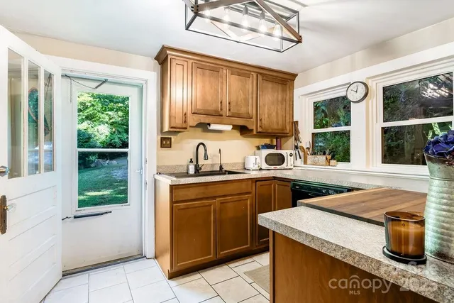 a kitchen with a sink and a stove top oven