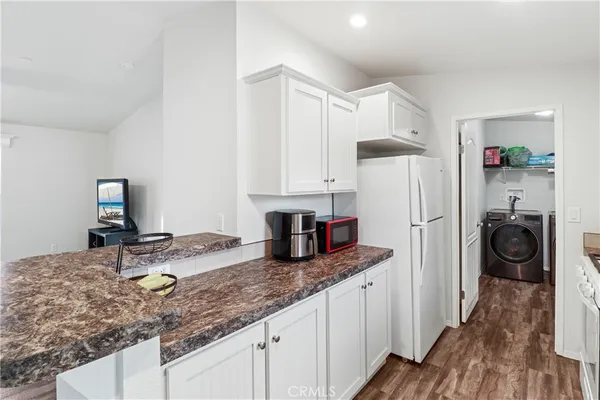 a kitchen with sink refrigerator and cabinets