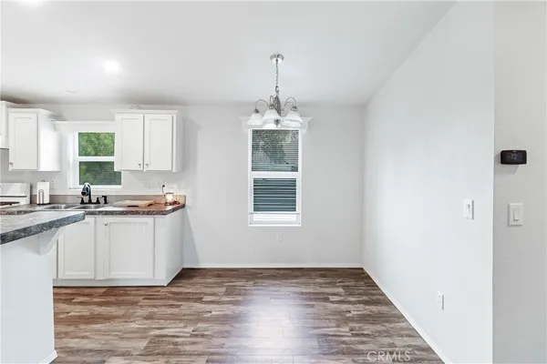 a kitchen with a sink window and cabinets