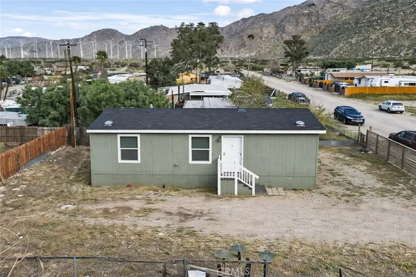 a view of a house with a yard and sitting area