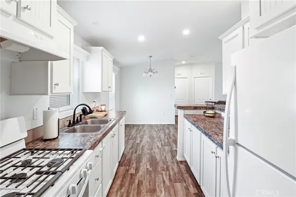 a living room with kitchen island furniture and a kitchen view