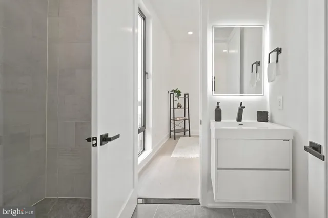 a bathroom with a sink a mirror and shower