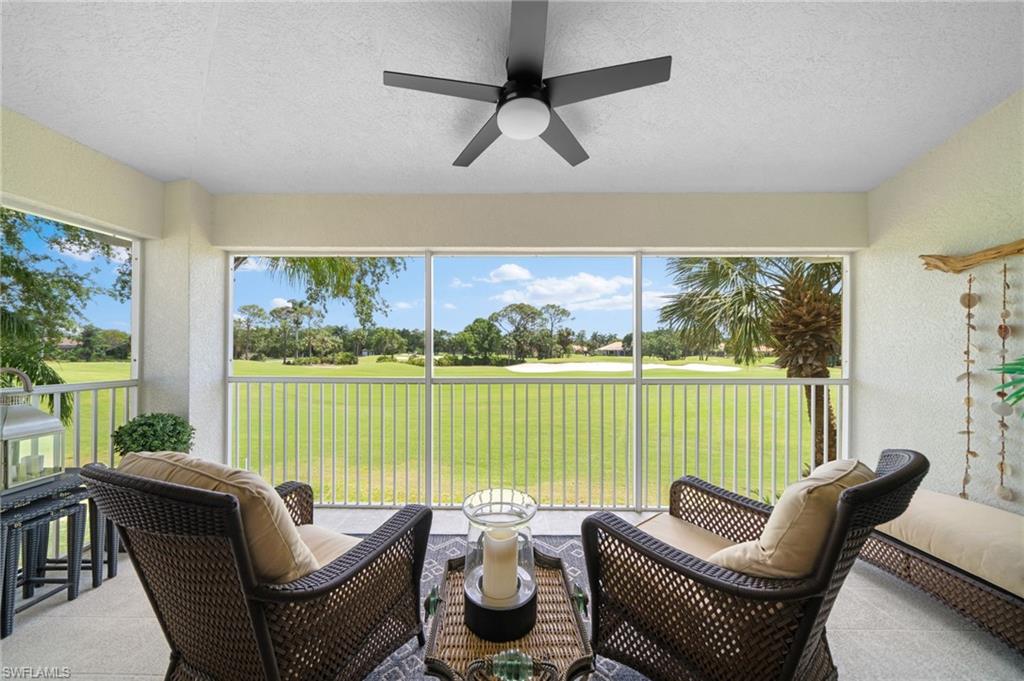 a living room with furniture and a floor to ceiling window