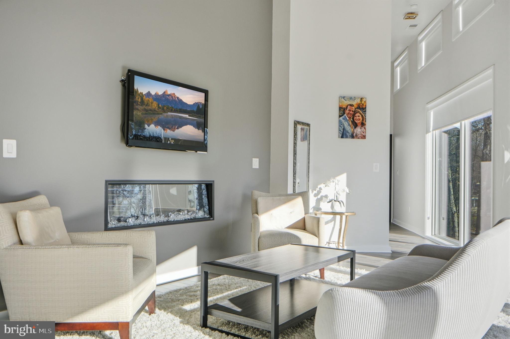 2368 Hunter Mill Road Vienna, VA 22181 - Photo 35 of 74 a living room with furniture and a painting on the wall