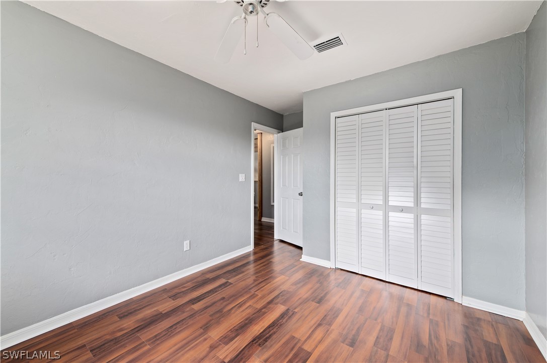 17381 Georgia Road Fort Myers, FL 33967 - Photo 25 of 34 an empty room with wooden floor and windows