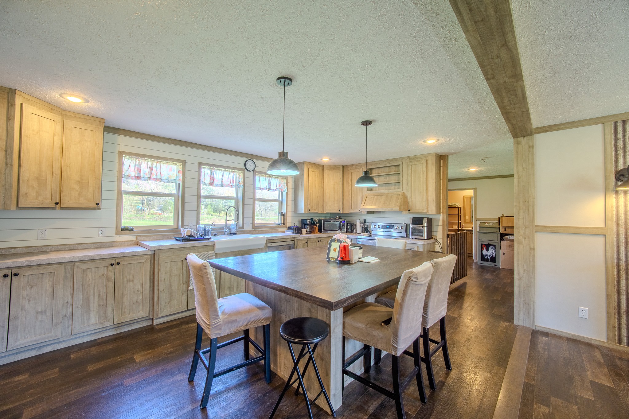 316 Morris Demps Road Sparta, TN 38583 - Photo 15 of 55 a kitchen with a dining table chairs wooden floor and appliances