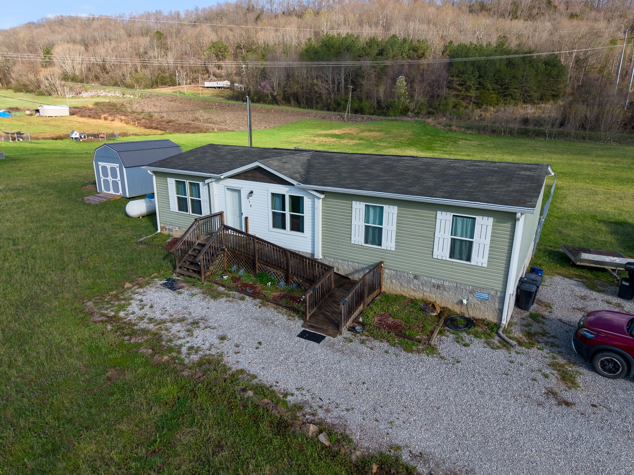316 Morris Demps Road Sparta, TN 38583 - Photo 45 of 55 a backyard of a house with a yard and outdoor seating