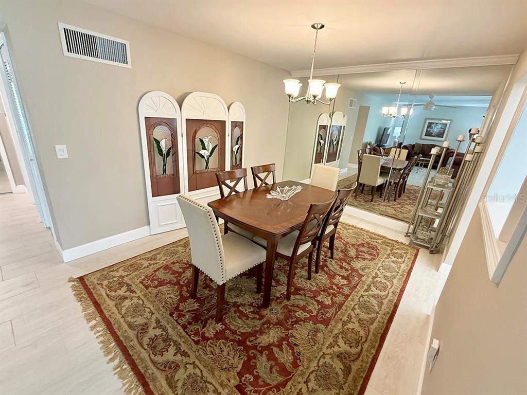 4455 Duhme Road, Unit 103 St. Petersburg, FL 33708 - Photo 13 of 37 a view of a dining room with furniture