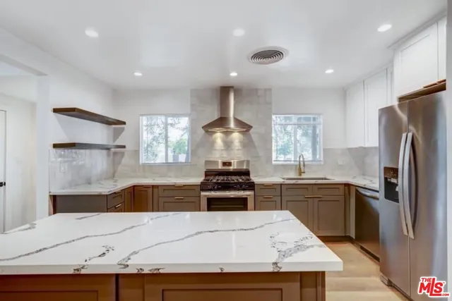 a kitchen with a stove a refrigerator and a sink