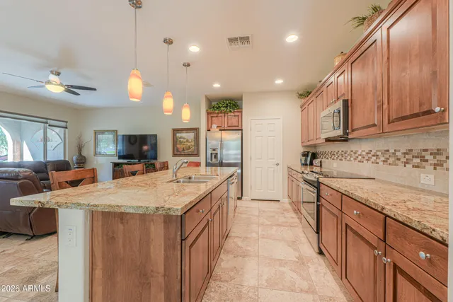 a kitchen with a refrigerator and a sink