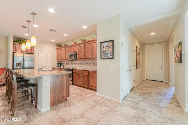 a open kitchen with stainless steel appliances granite countertop a sink and cabinets