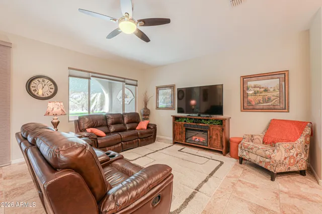 a living room with furniture kitchen view and a chandelier