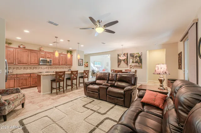 a living room with furniture a dining table and kitchen view