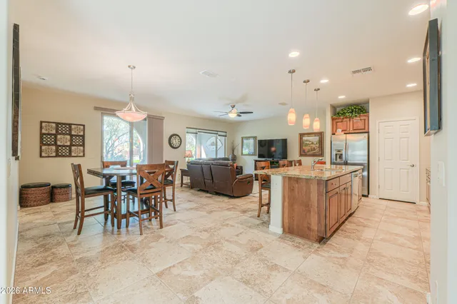 a view of a dining room and livingroom with furniture a flat screen tv